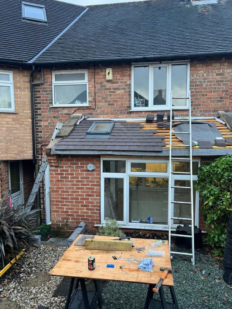 This is a photo of a roof extension that is having new roof tiles installed. This is a photo taken from the roof ridge looking down a tiled pitched roof on to a flat roof. Works carried out by East Bridgford Roofing Repairs