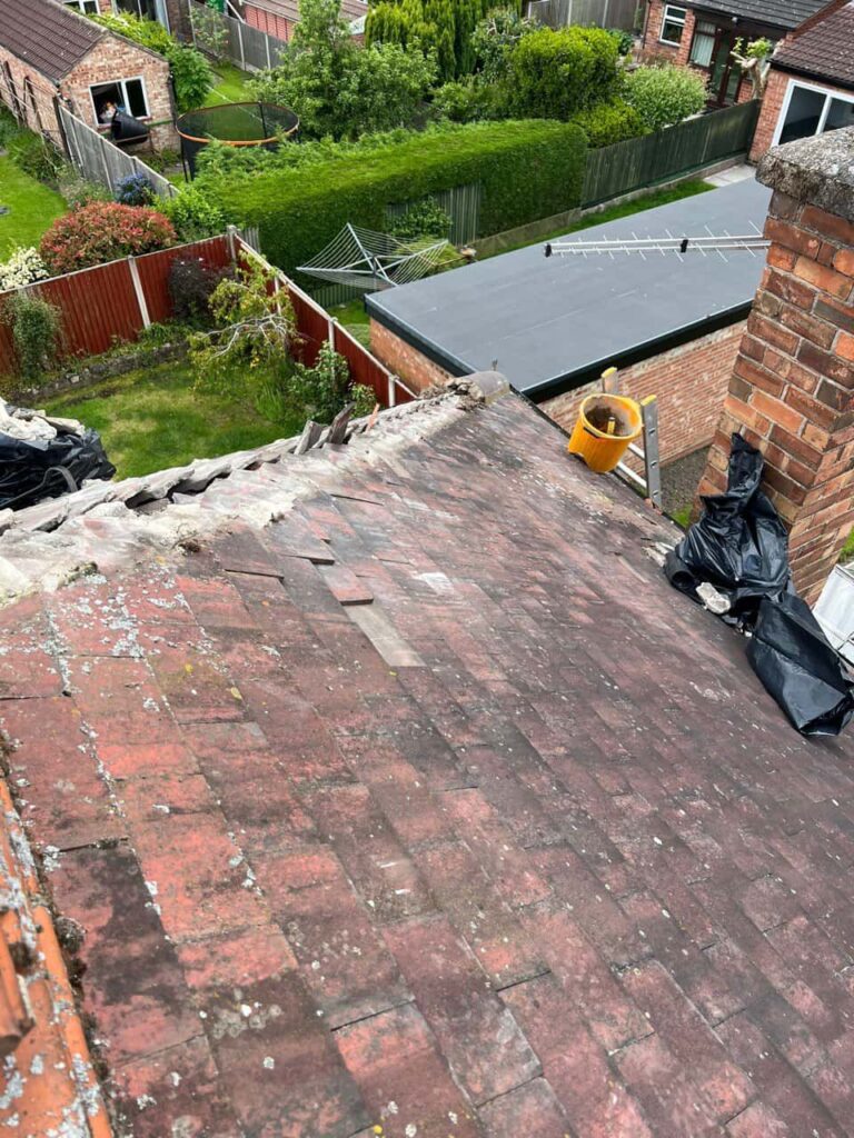 This is a photo of a roof where the hip tiles have been removed, and are just about to be replaced. Works carried out by East Bridgford Roofing Repairs